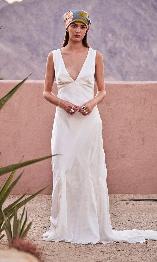 Elegant woman in white dress and headscarf outdoors
