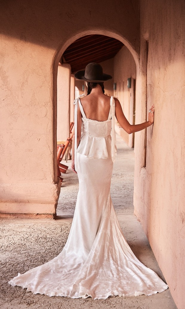 Boho bride in white gown and hat, desert wedding vibe