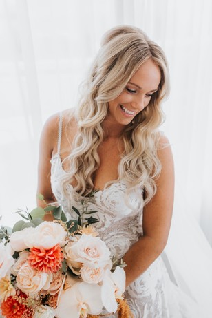 Smiling bride holding a bouquet of flowers on her wedding day