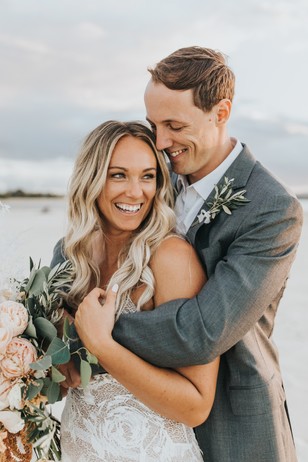 Happy bride and groom embracing on their wedding day