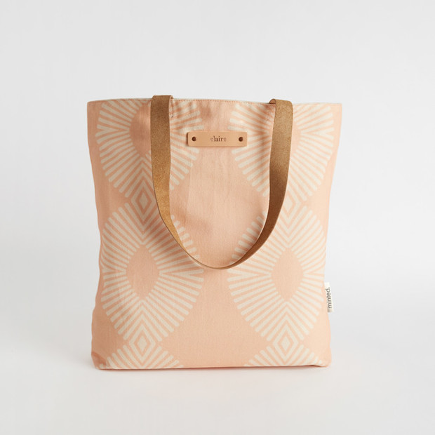Pink tote bag with geometric print and leather handles