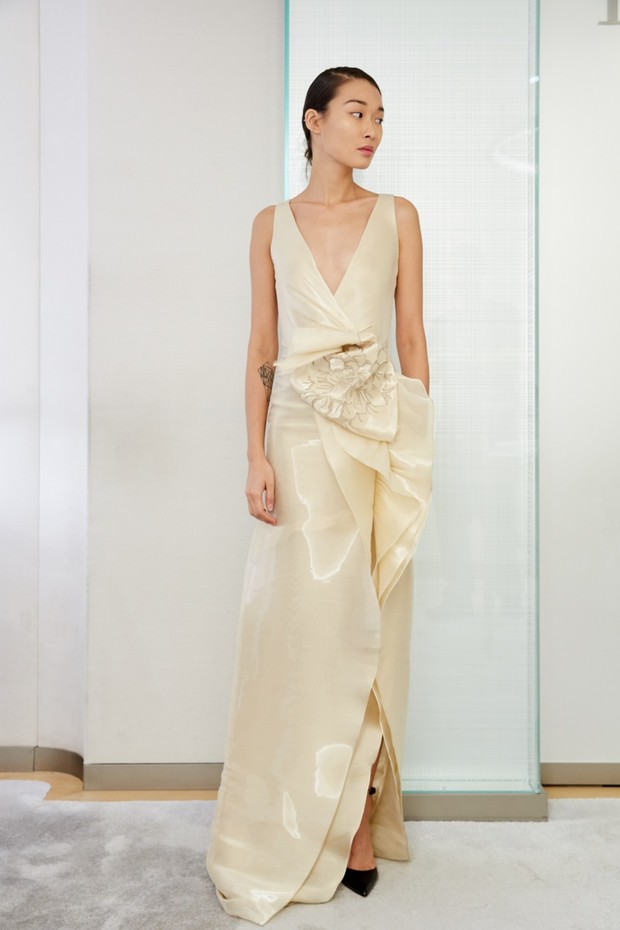 Elegant woman in cream-colored gown with unique floral detail