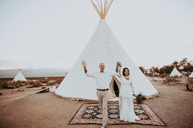 Newlyweds celebrate their wedding at a bohemian desert tipi venue