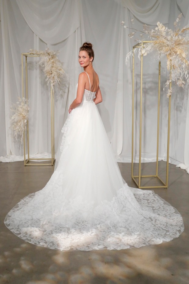 Woman in a beautiful lace wedding gown with long train