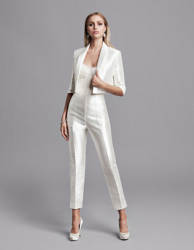 Elegant woman in a white jumpsuit and blazer, formal fashion