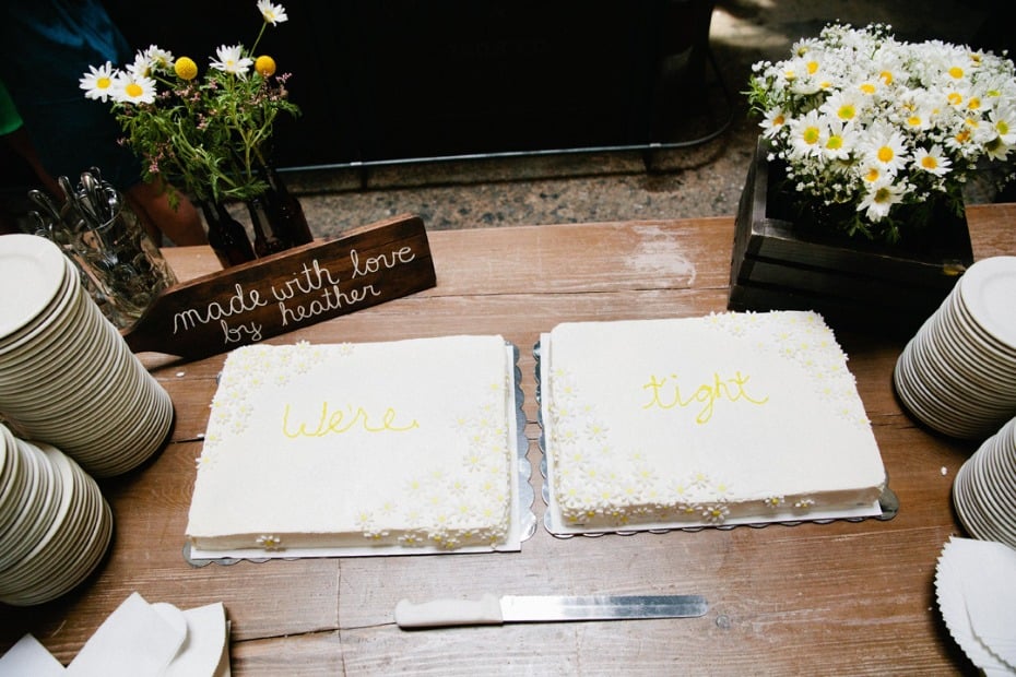 Bride and groom's wedding cake table - cakes say 'We're tight"
