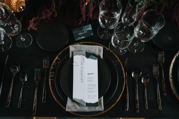 black and gold moody wedding place setting