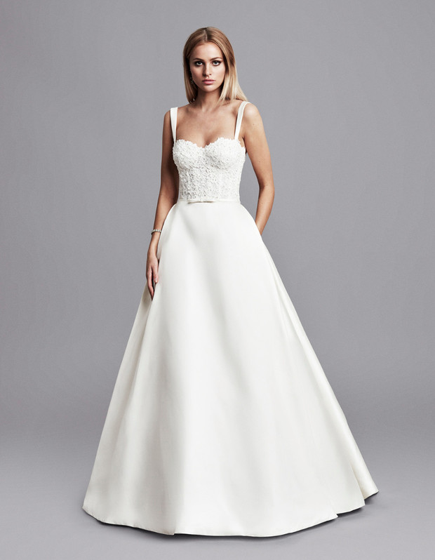 Elegant bride in a white ball gown wedding dress posing