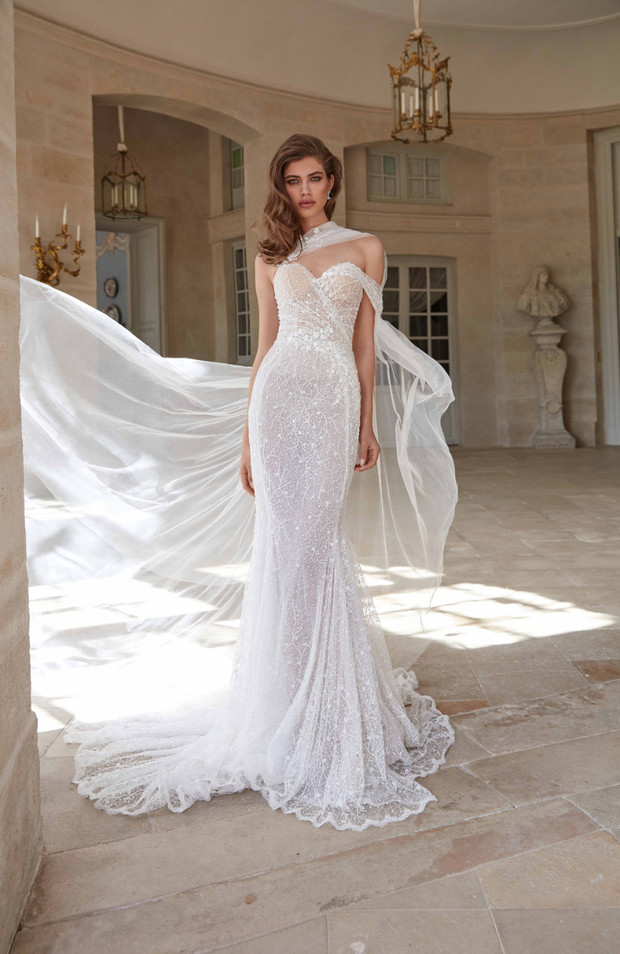 Elegant bride wearing a shimmering white wedding dress in a palace