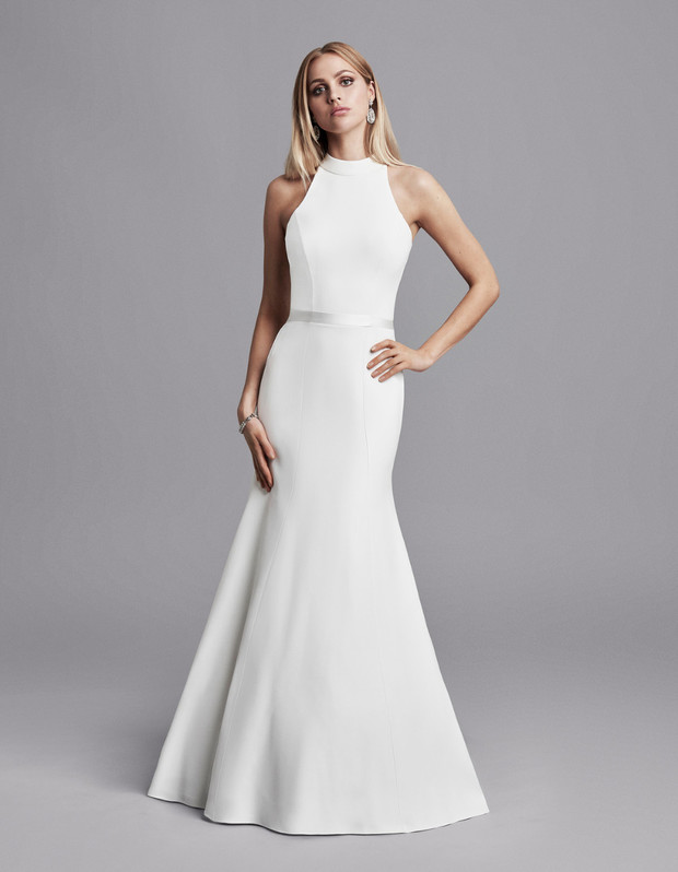 Elegant bride in a white halter neck mermaid wedding dress