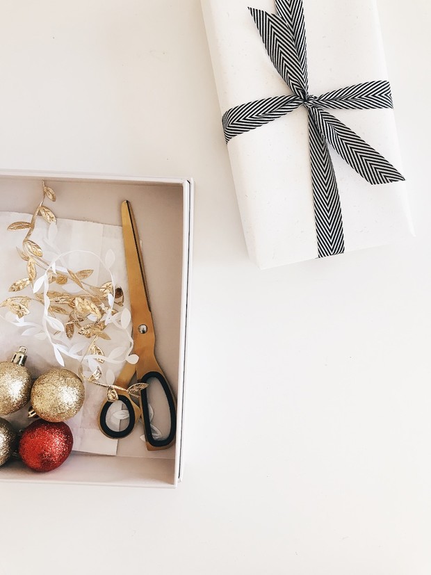 Christmas gift wrapping with gold scissors and decorations