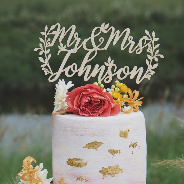 Wedding cake with Mr & Mrs Johnson topper and floral decorations