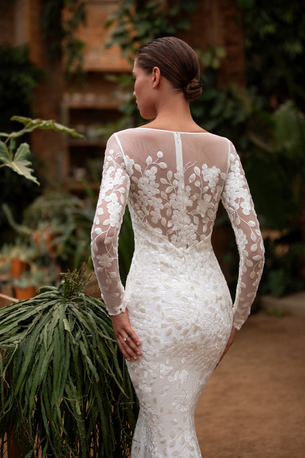 Woman in elegant floral lace wedding dress back view