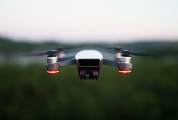 Drone in flight capturing aerial view with blurred background