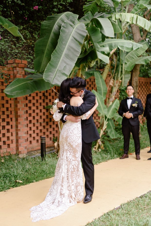 Bride and groom embrace in joy at their wedding ceremony