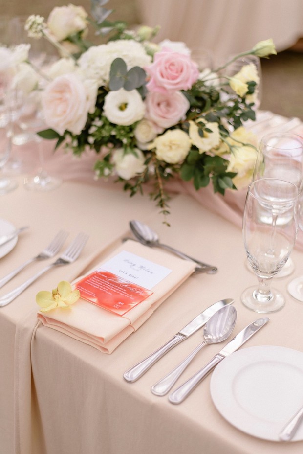 Elegant wedding table setting with floral arrangement and menu card