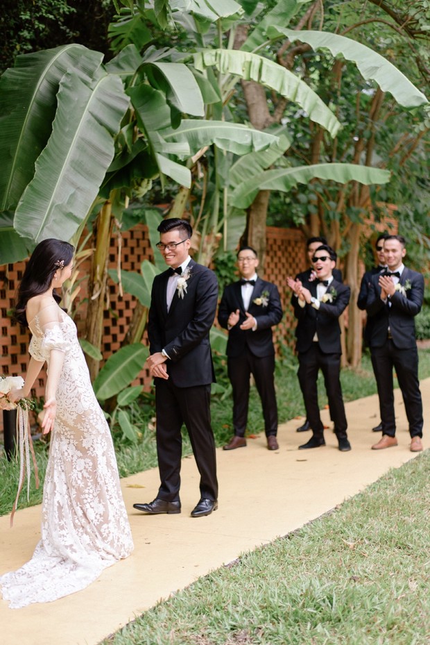Bride walking towards groom during a outdoor wedding ceremony