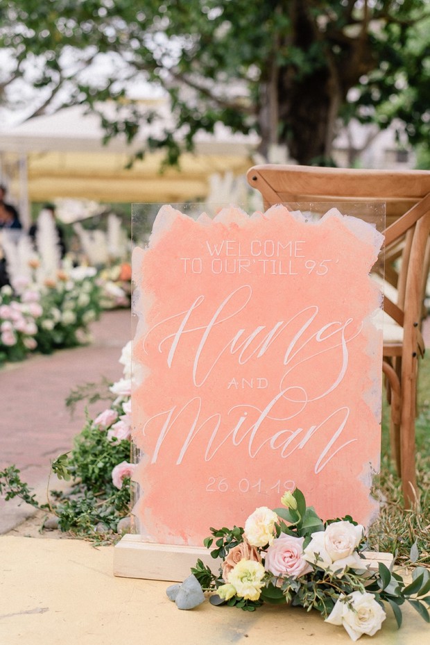 Wedding sign with names and flowers on the ground, in the ceremony