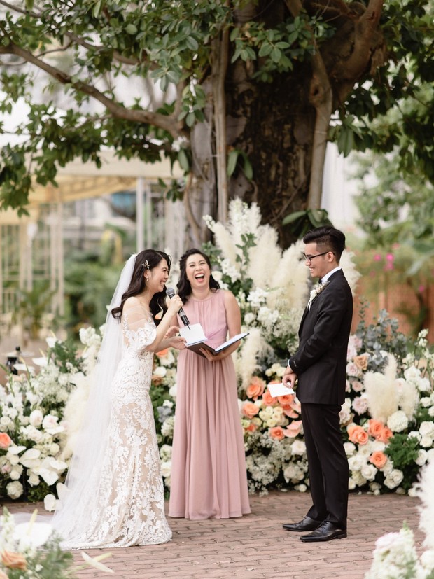 Bride and groom laugh during outdoor wedding ceremony