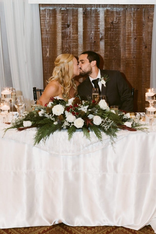 sweetheart table with kissing couple