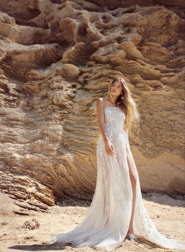 Stunning bride in a lace wedding dress posing outdoors