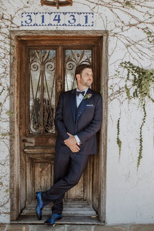 groom in bespoke suite and blue shoes