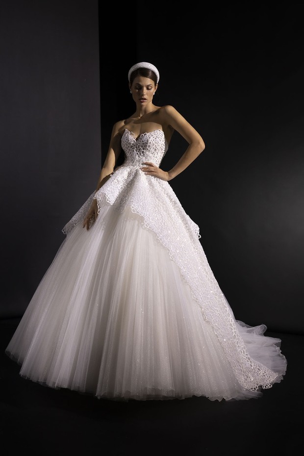 Elegant bride in a stunning white wedding dress posing confidently