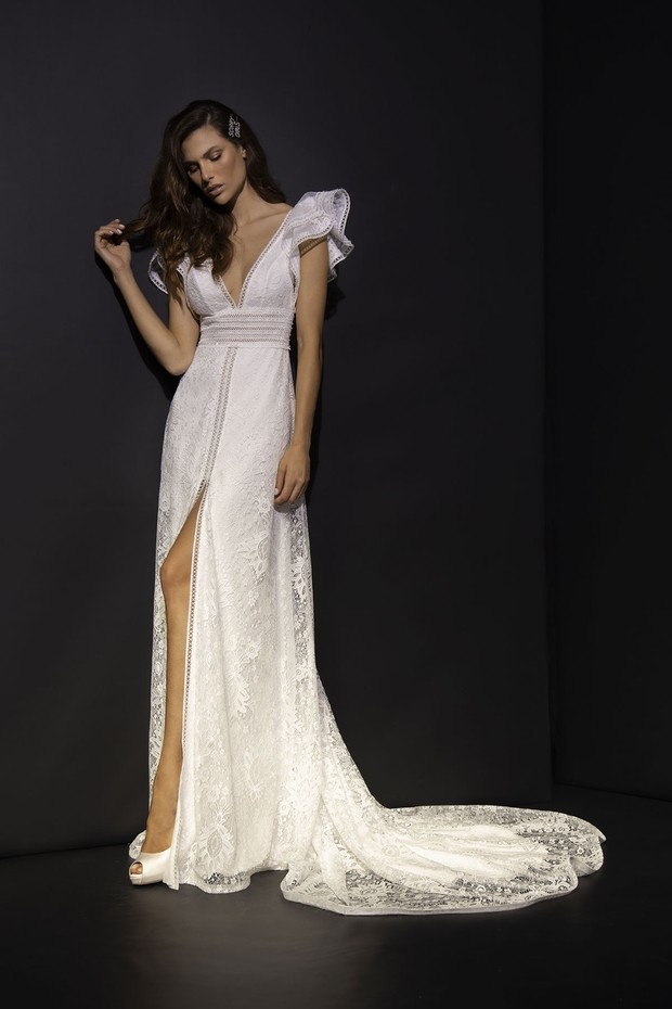 Elegant bride wearing a white lace wedding dress with a long train