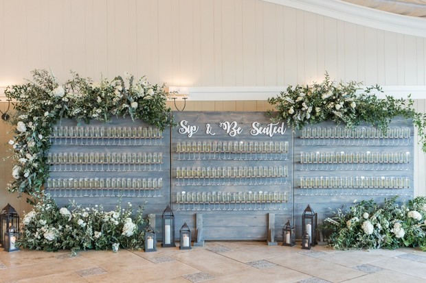 sip and be seated wedding seating chart champagne wall