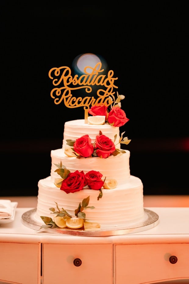 red rose topped wedding cake