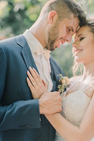 Loving couple on their wedding day embracing with smiles