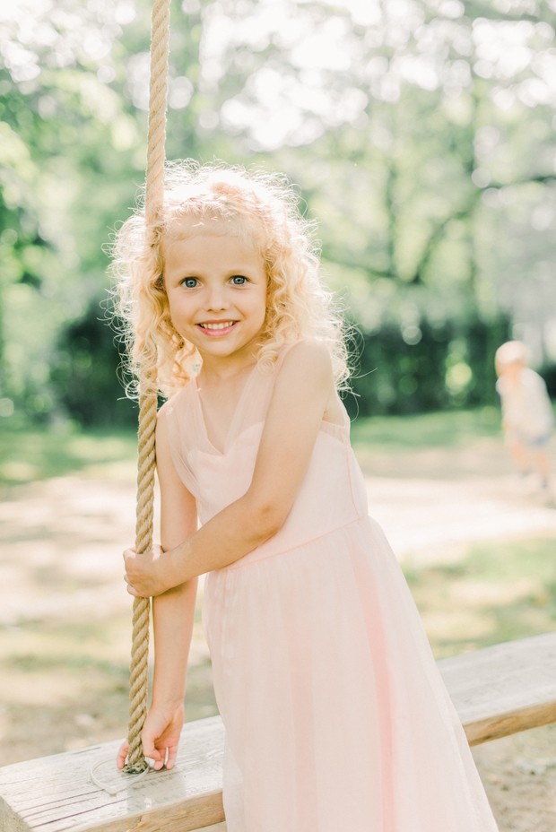sweet little flower girl in blush dress and curly hair