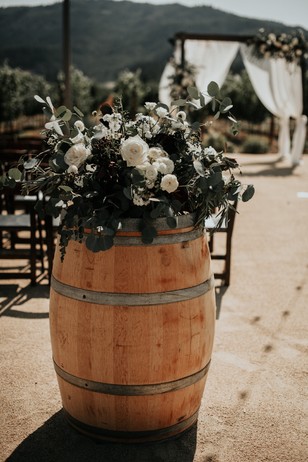 wine barrel floral decor for your wedding aisle