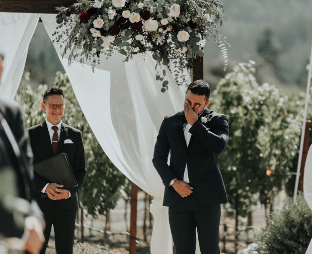 teary eyed groom seeing his bride for the first time