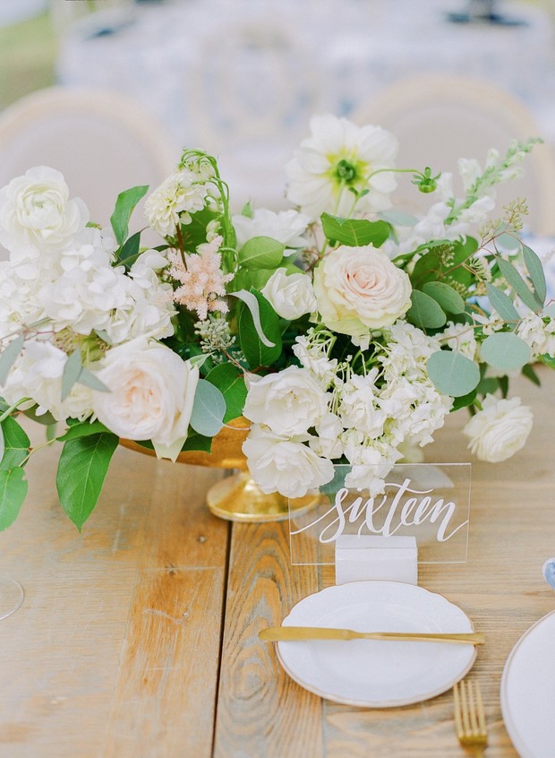 Wedding table setting with floral centerpiece and number sixteen
