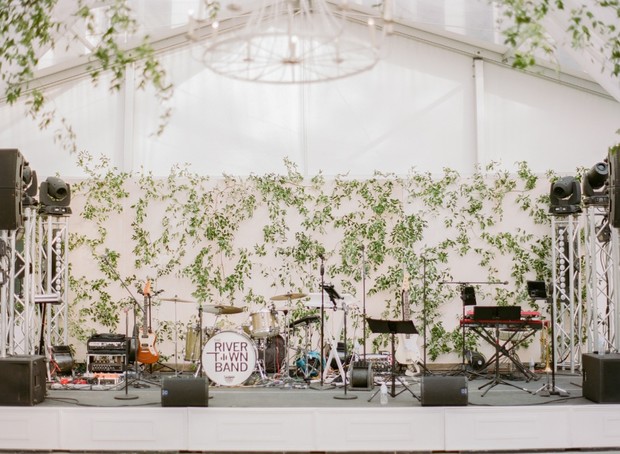 River Town Band stage setup with greenery backdrop