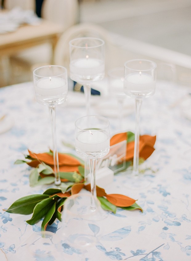 Elegant candle centerpiece with magnolia leaves decor