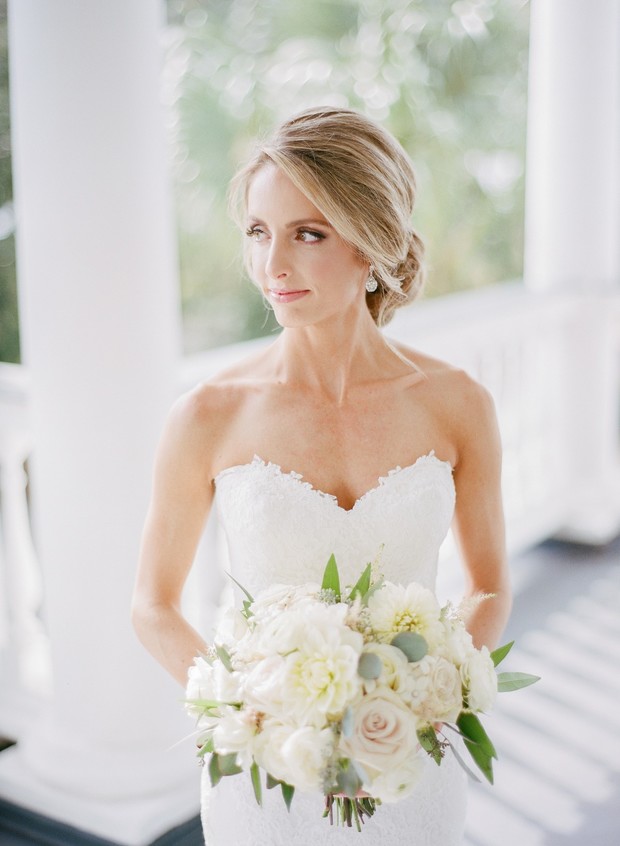 Elegant bride holding a white floral bouquet wedding day