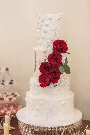 rose accented white wedding cake