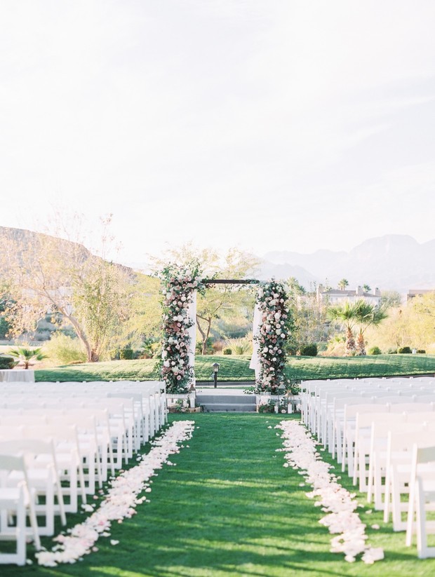 Outdoor wedding ceremony setup with floral archway