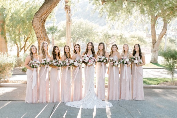 Bride and bridesmaids in pink dresses with bouquets