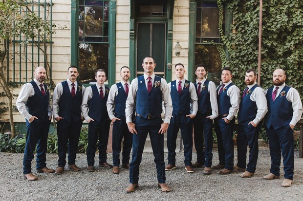 groom and groomsmen in navy slacks and vest look