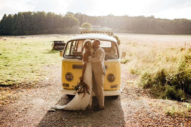 wedding couple with their yellow VW bus getaway car