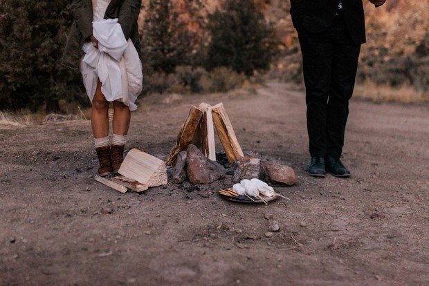 Couple near campfire with marshmallows for a wedding
