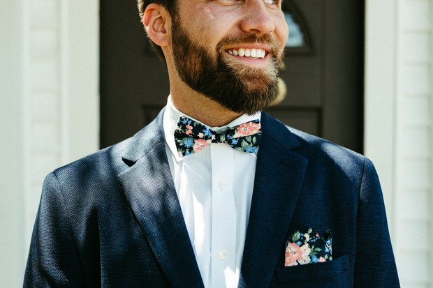 groom in navy and floral bow tie