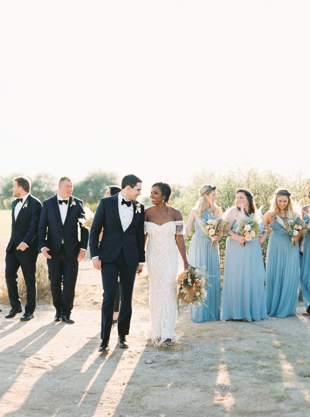 wedding party in black tie and soft blue