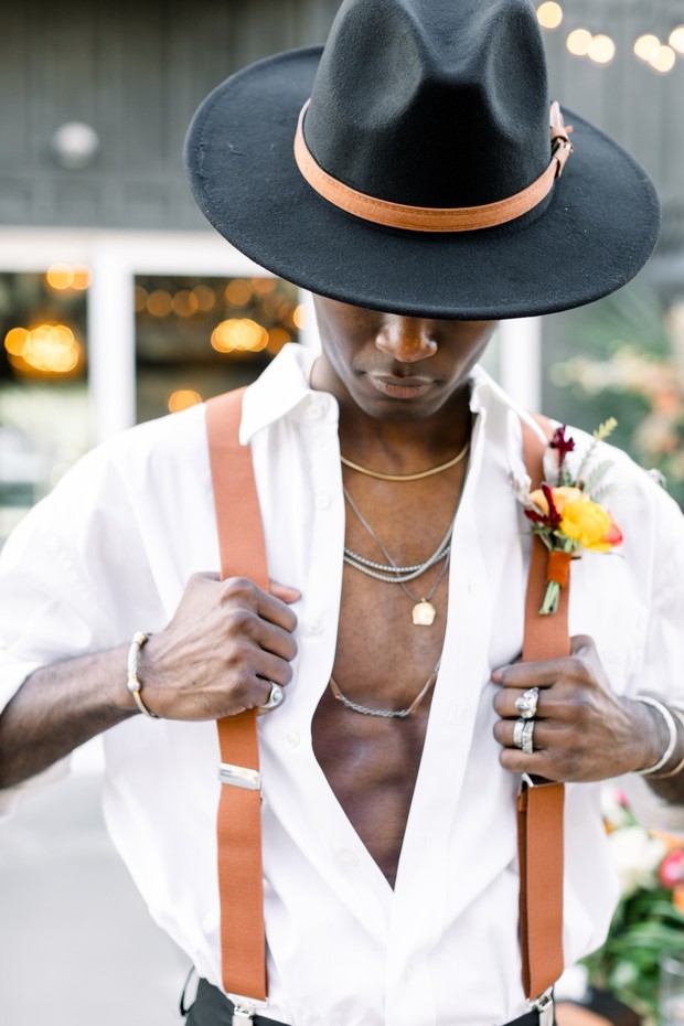 sexy groom in hipster hat and leather suspenders