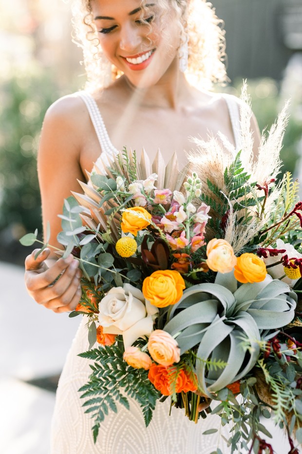summer time wedding bouquet in yellow orange and air plants