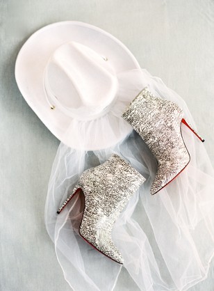 White cowboy hat and sparkling red sole boots fashion