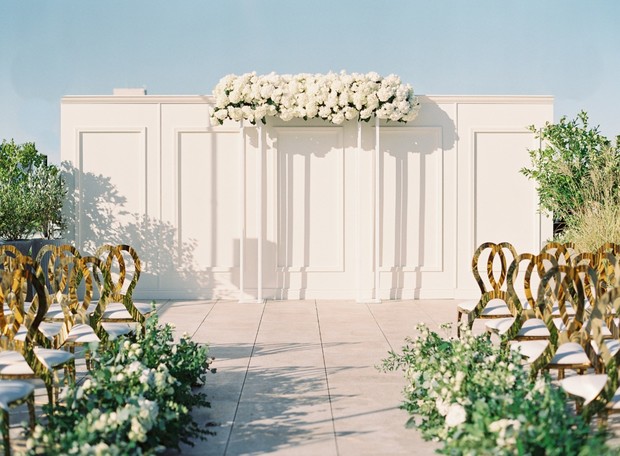 Elegant rooftop wedding ceremony setup with floral decorations